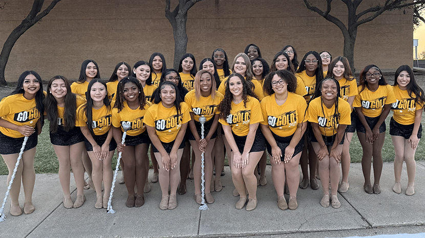 A group of students in rows. They all wear yellow shirts that say Go Gold on the front.
