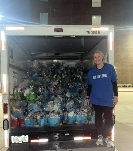 a woman in front of a truck loaded with bags