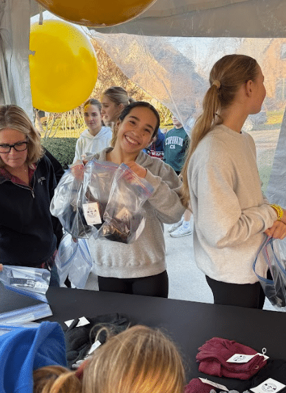 a person holding up a ziploc bag and smiling at the camera