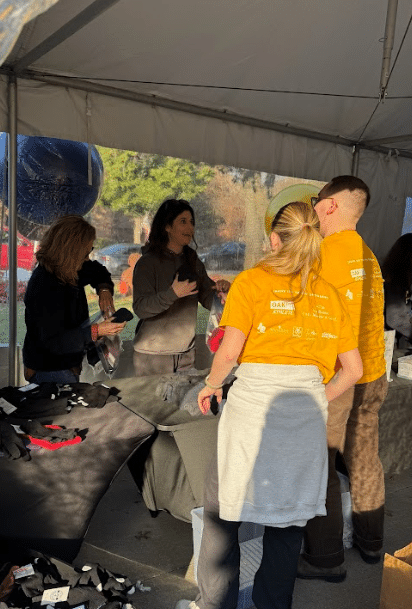 People working at a table in a tent