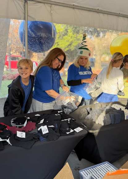 People working at a table in a tent