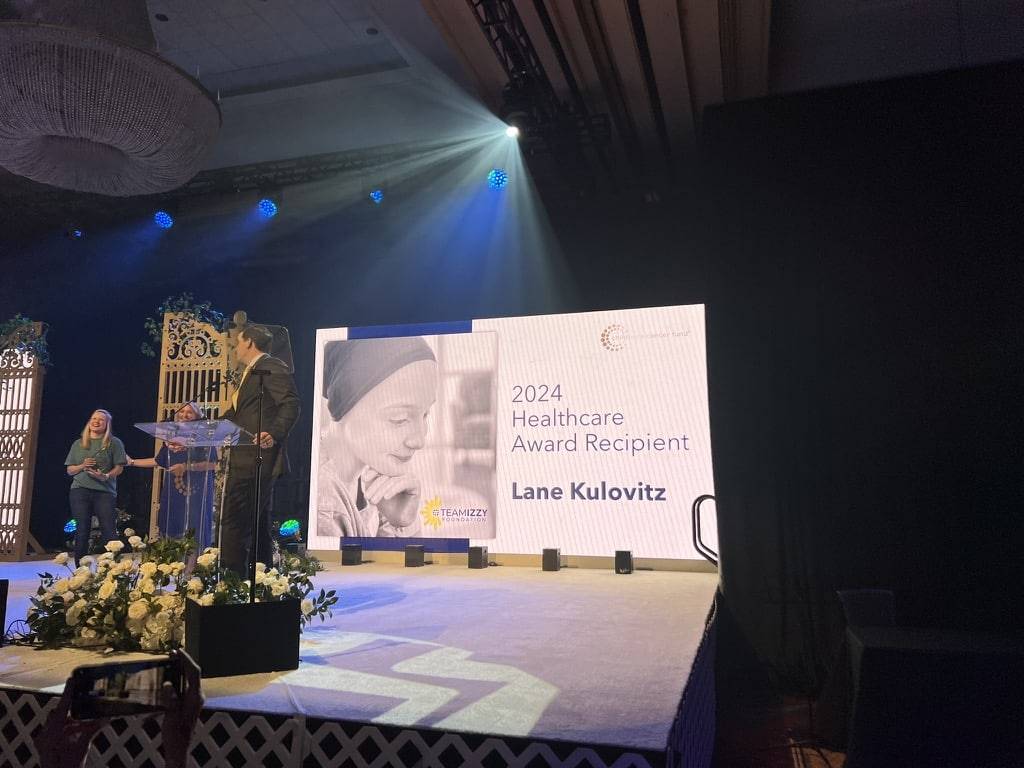 An image of a stage with a large backdrop that says 2024 Healthcare Annual Recipient
