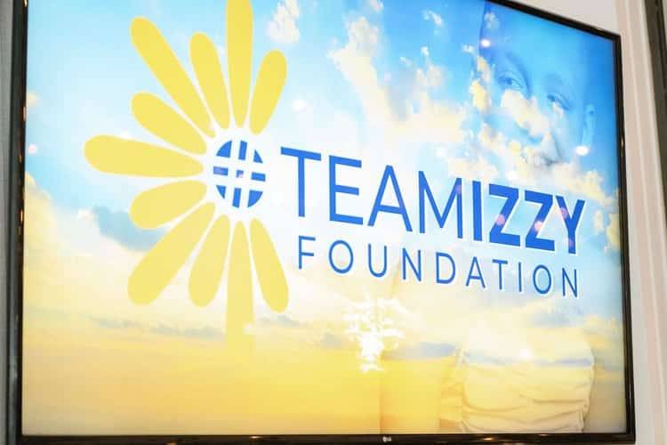 a monitor with an image that says TeamIzzy Foundation on it