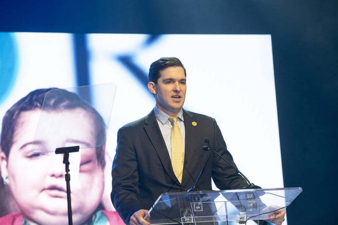 A man making a speech on a stage