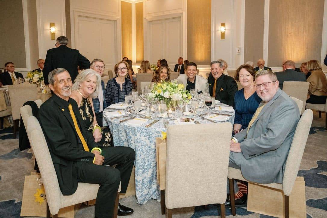 a group of people at a round dining table