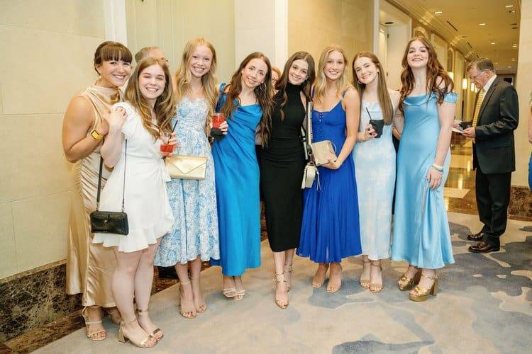 a large group of women in a photo. all are in dressy clothing